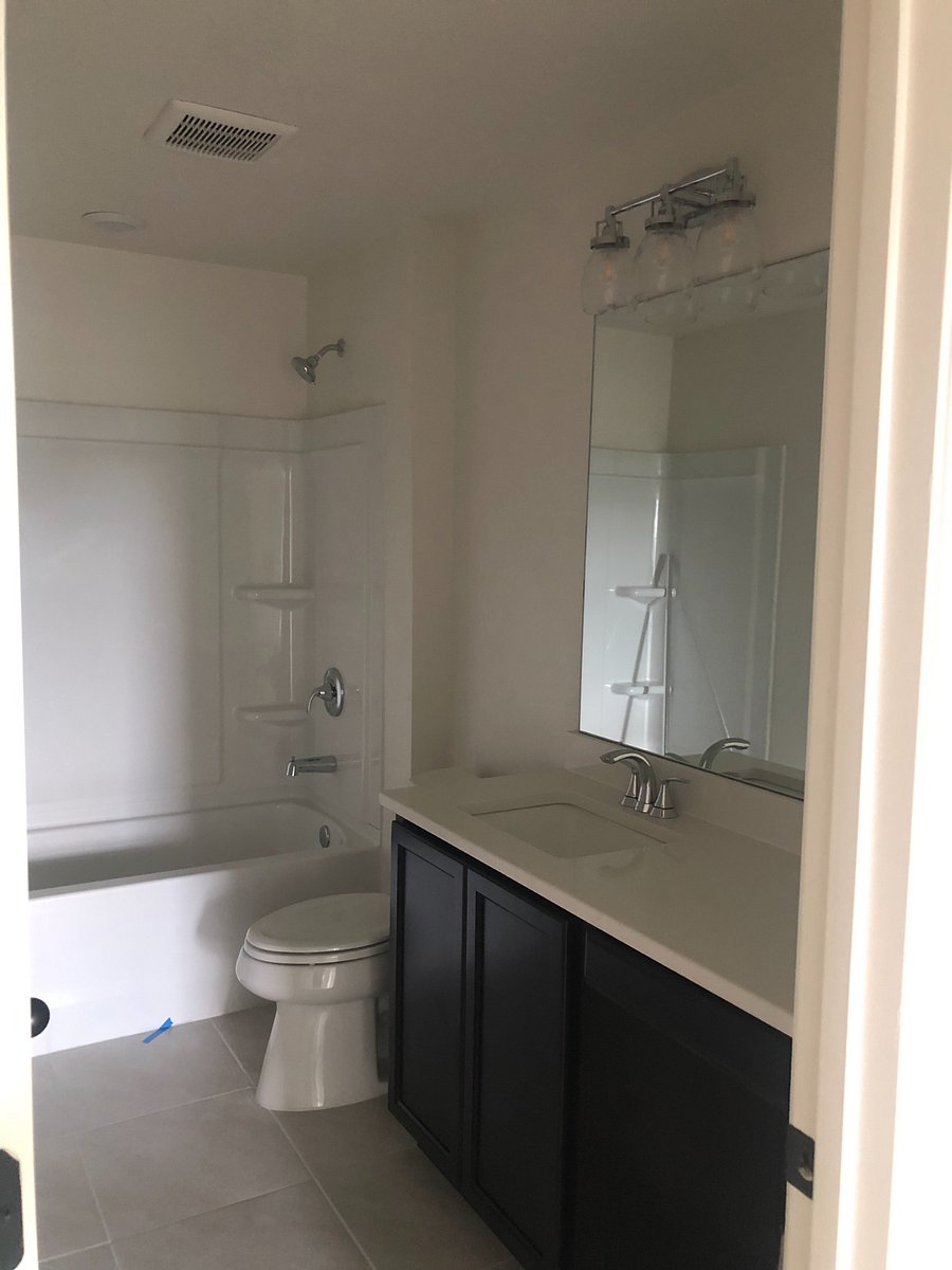 This is the bathroom located adjacent to the upstairs bedrooms. It will have a shower curtain. It has a large counter space.