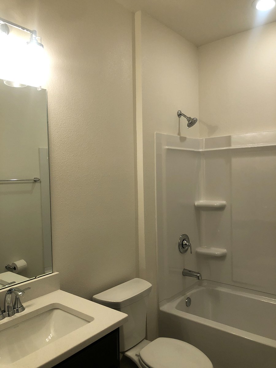This is the downstairs bathroom which is adjacent to the furnished bedroom. It has a seeded glass light fixture, undermount sink and quartz countertops. It will have a shower curtain.