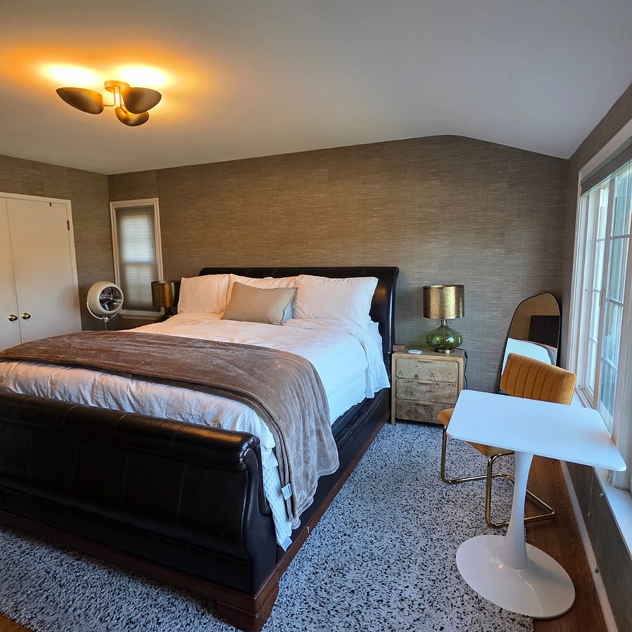 King sized bed with crisp white linen. Velvet dining chair and eat in table for moments of privacy and peace. 