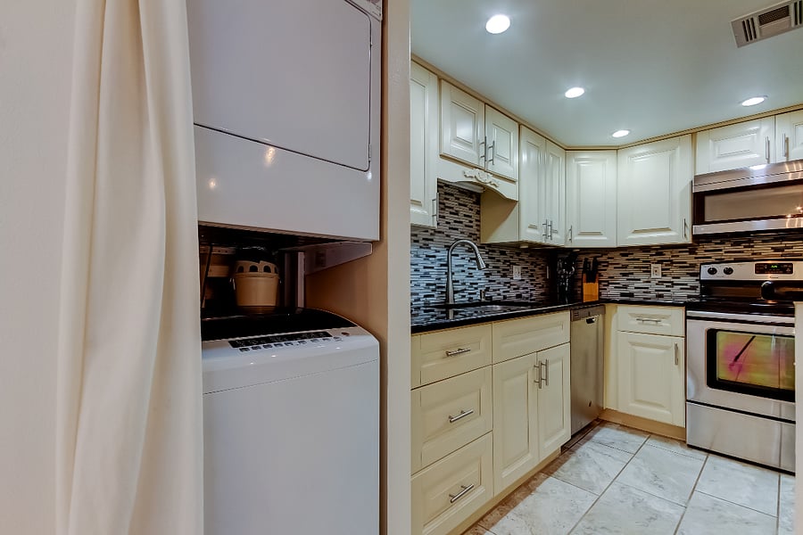 Renovated Kitchen with Granite Counters and Stainless steel appliances. Inside Laundry.