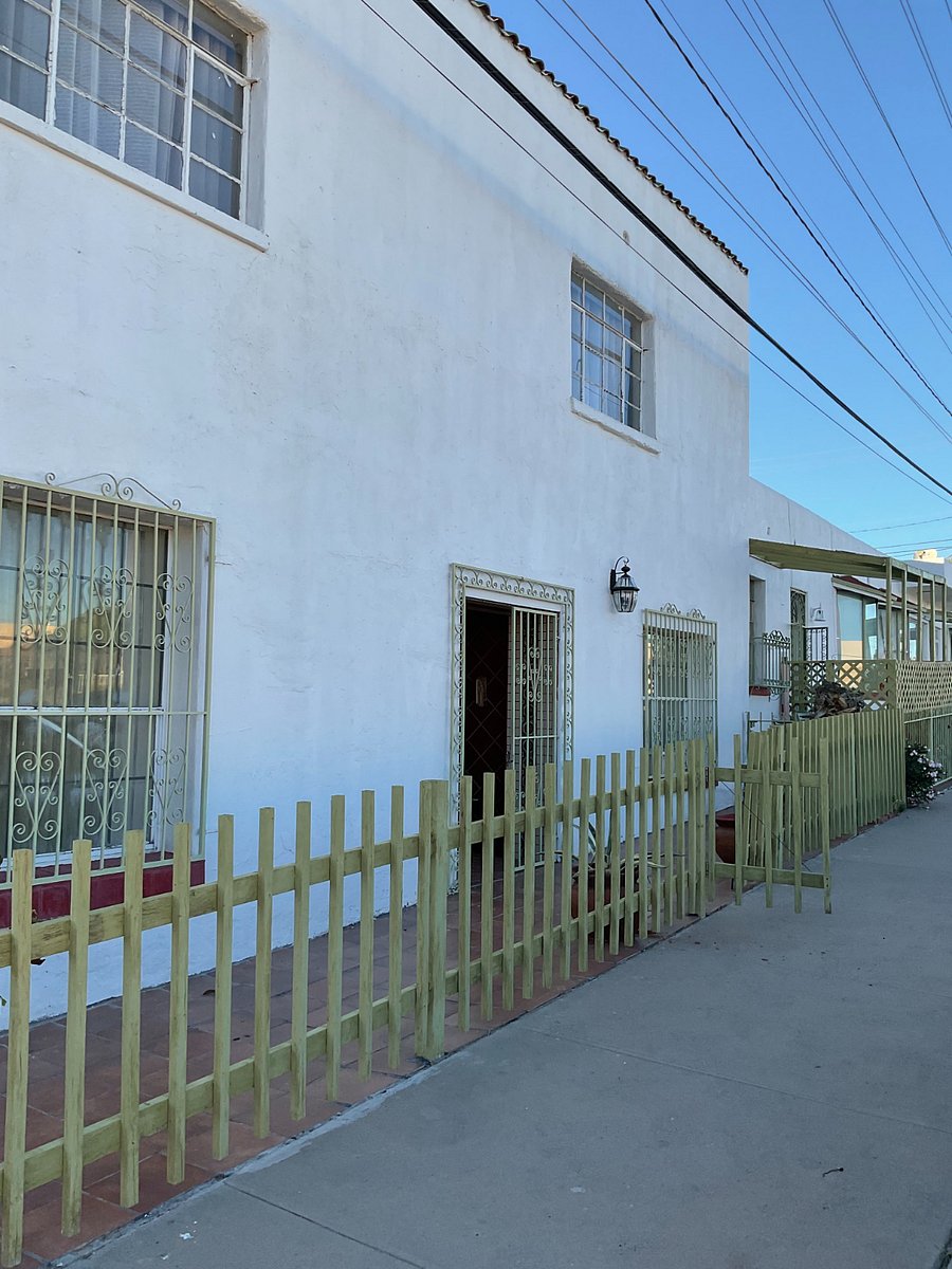 Front of home with security gates at entrance.