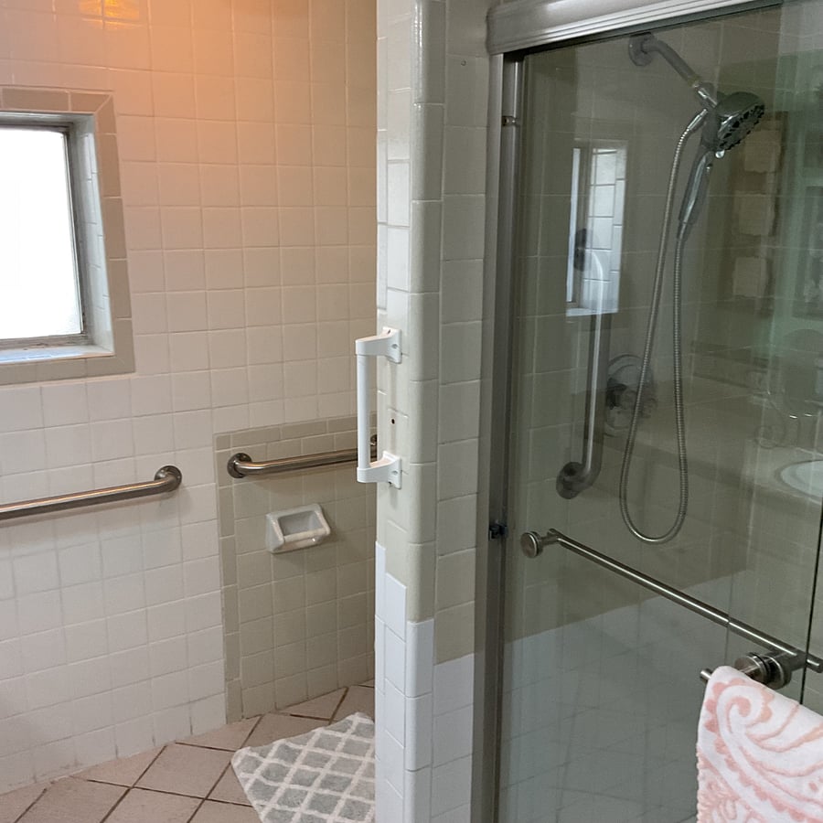 Downstairs shower with glass doors.
