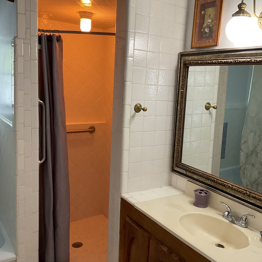 Upstairs bathroom featuring stand alone shower, bathtub and toliet and vanity. This bathroom is on the second level of the house.