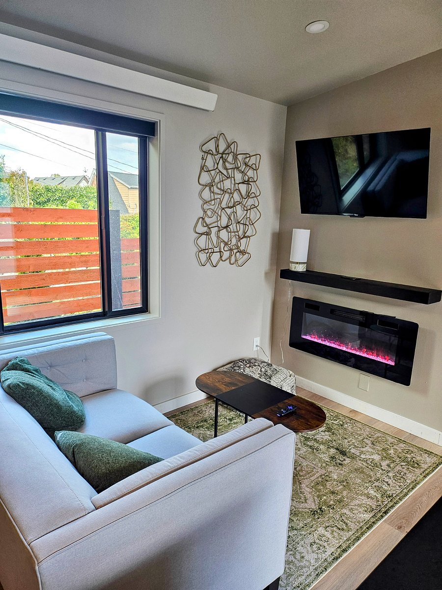 Comfortable lounging area with a fireplace and a Roku smart TV.