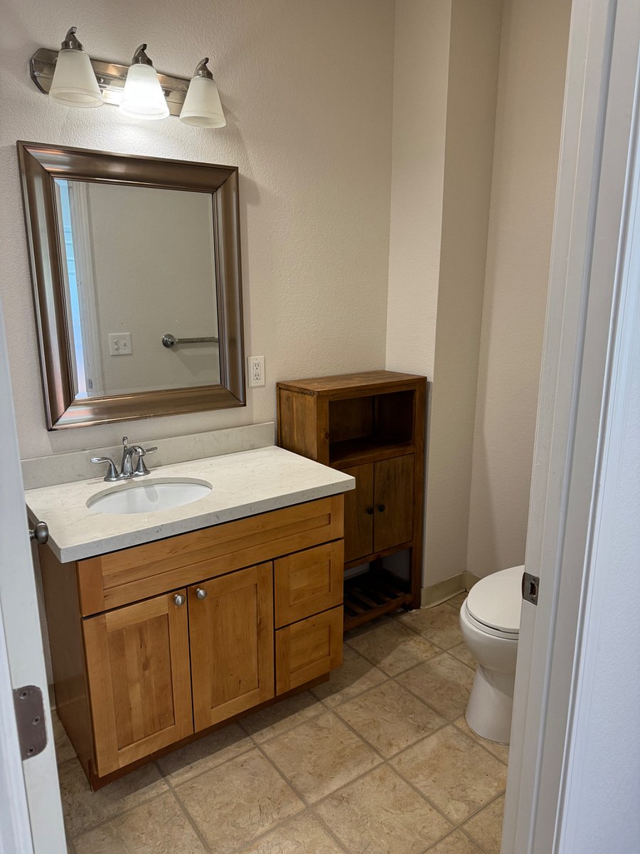 The full bath has a walk in shower and a newly installed heat lamp.