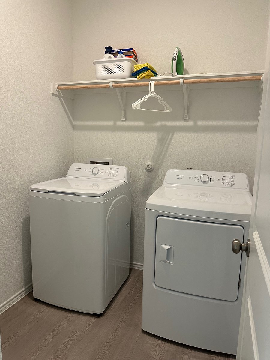 Washer and dryer on the main level with iron and laundry board. 