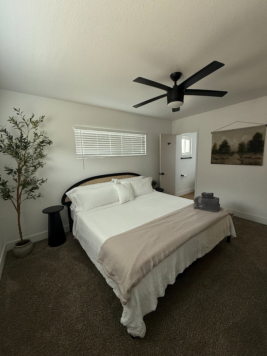 Master bedroom, King bed, attached private bathroom from the rest of the house (visible door in the image), large closet with an extra fan, hangers, and laundry basket.
