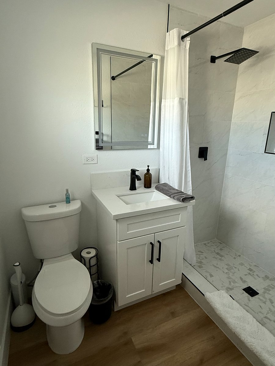 Master bathroom, waterfall shower head. Shampoo and conditioner provided.