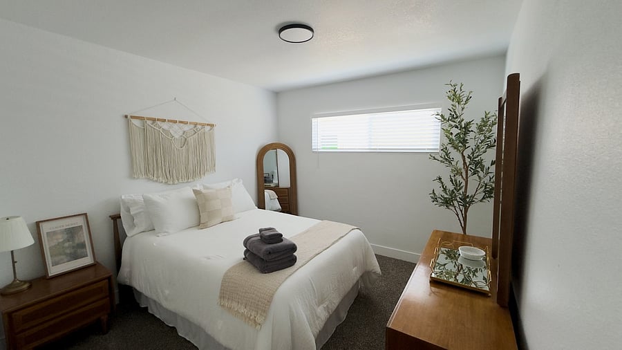Secondary Bedroom, large closet, dresser storage, hangers, and laundry basket in the closet.