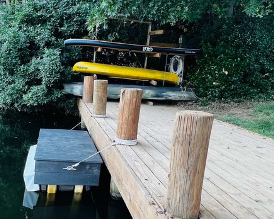 Our community dock with shared (free) canoes and paddle boards. It is a few minutes walk from the house.