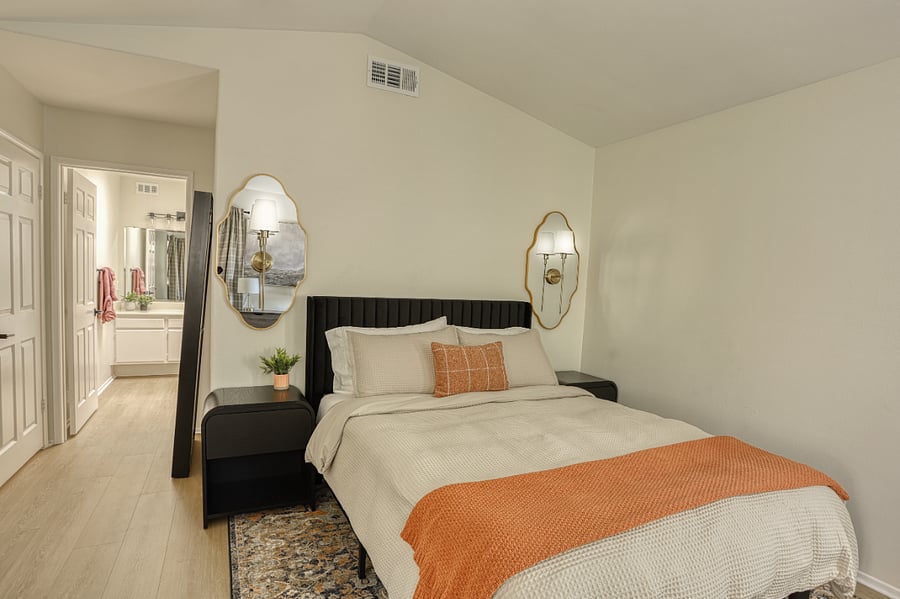 Your quiet, stylish retreat. Relax in this Queen suite featuring a plush rug, elegant arched mirrors, and a comfortable bed with luxurious linens. Designed for deep rest and recharging during your long-term stay.