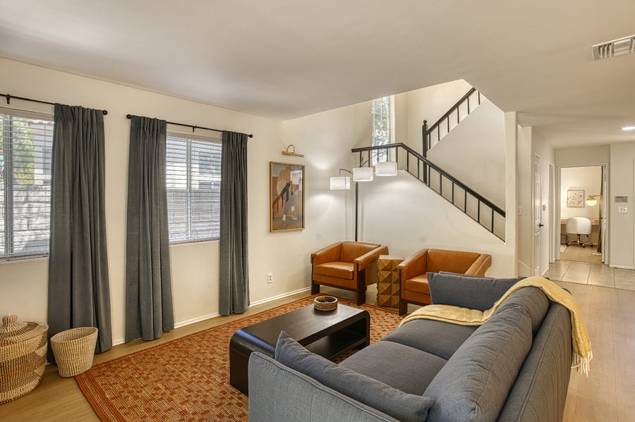 Sunlight and comfort define this space. Enjoy a bright, airy environment with modern furnishings and a layout designed for real living. Perfect for unwinding after a long day or getting some work done at the adjacent dining table.