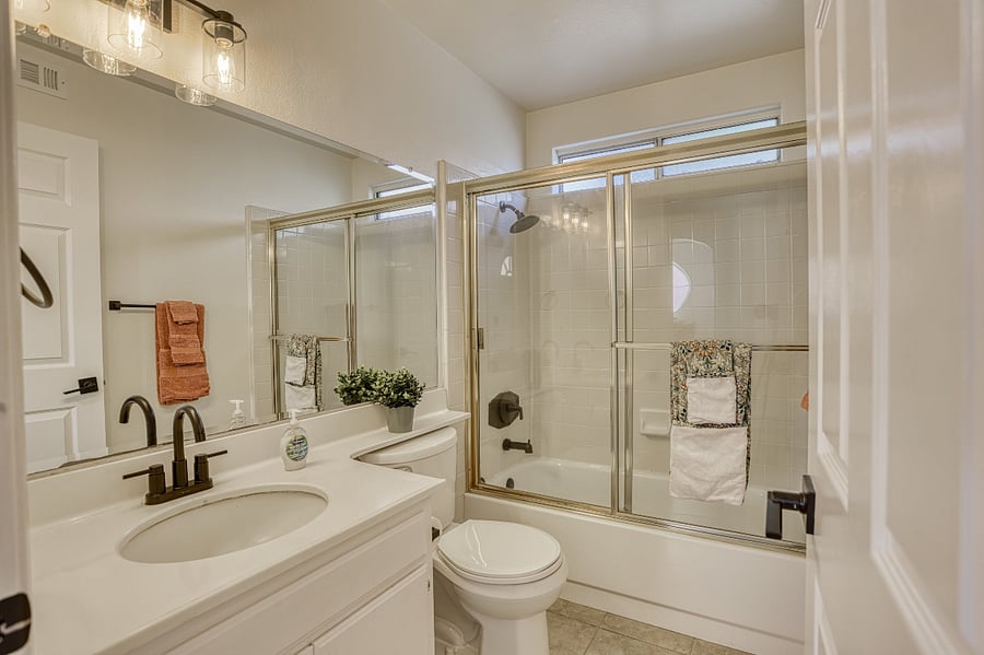 Freshen up in this clean and contemporary bathroom, featuring a crisp white aesthetic and thoughtful designer touches. This bright space is fully equipped to provide a comfortable and high-end experience for every guest.
