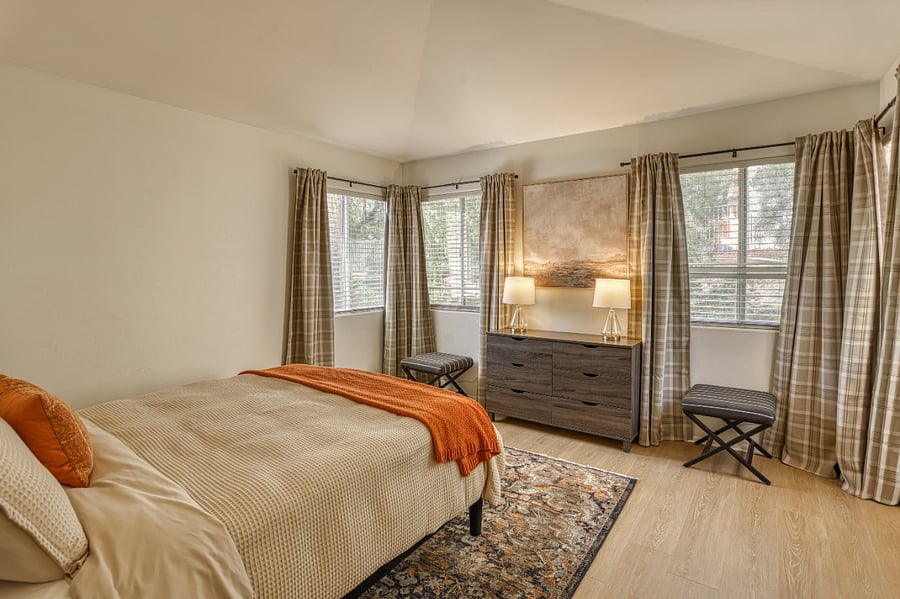 Wake up in this bright and expansive bedroom, where large windows and vaulted ceilings create an open, airy atmosphere. Designed with a perfect blend of modern comfort and rustic charm, this room serves as the ultimate relaxation zone.