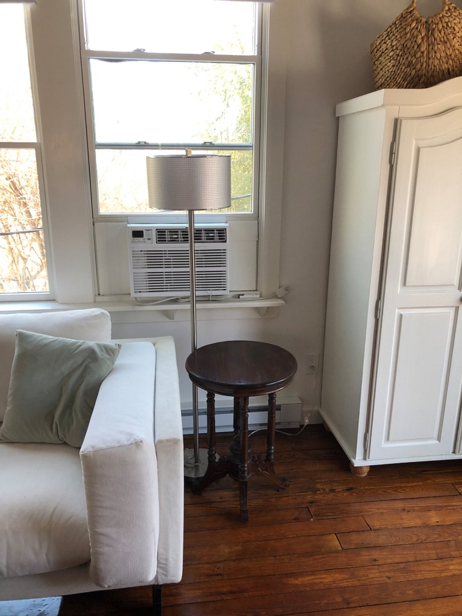 Window a/c unit. Small armoire to the right.