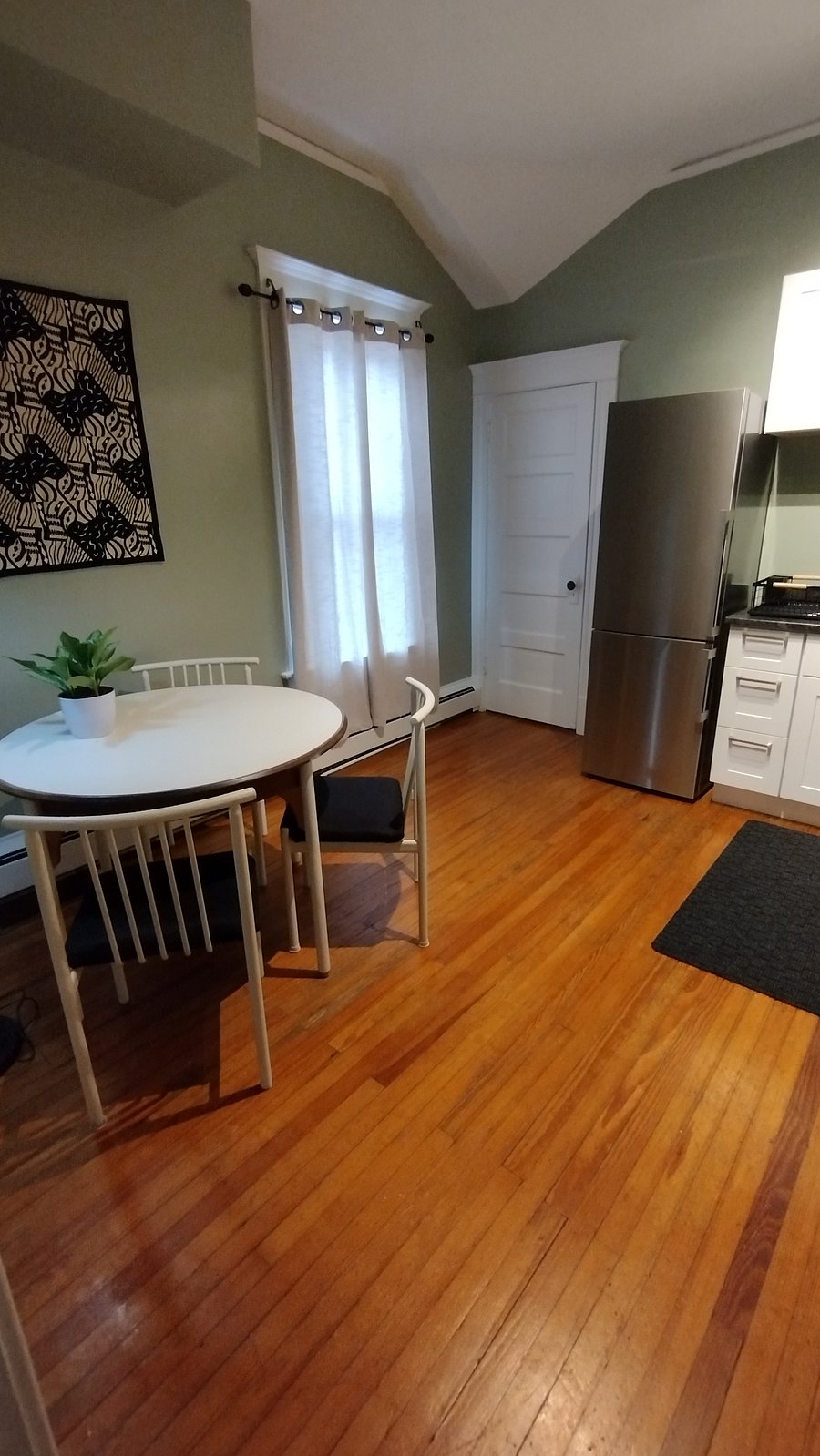 The other side of the kitchen with a nice round table and three chairs.
The door to the left of the refrig is the entrance to the bathroom area.