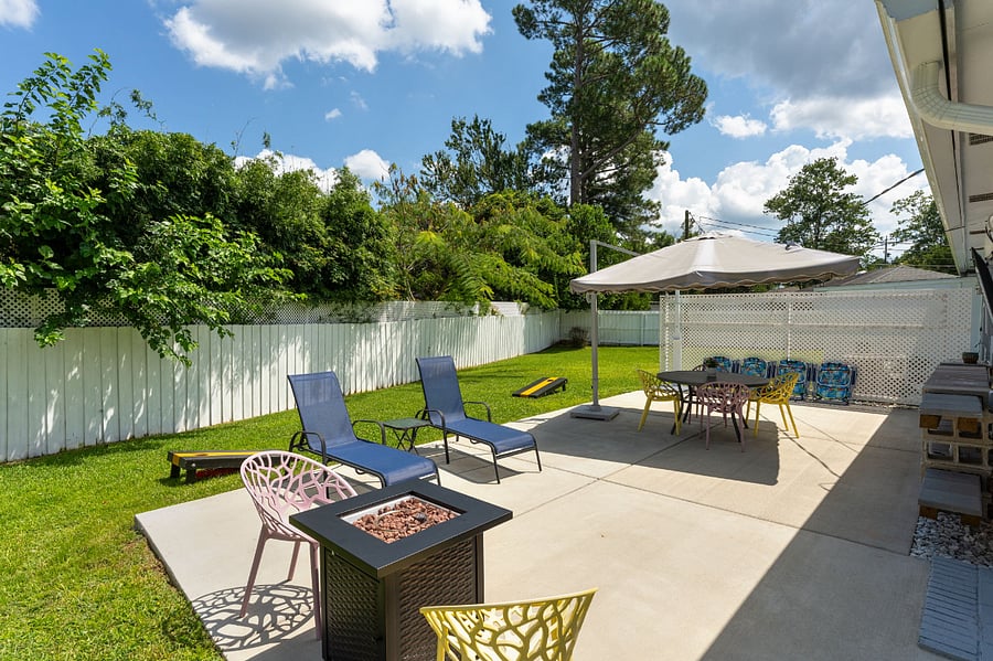 Large Patio with Outdoor Shower, Sink, TV, Fire Table, Umbrella, and plenty of seating