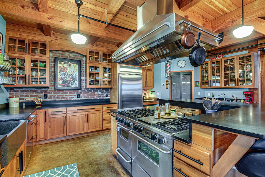 Chef's kitchen complete with stainless steel appliances, six-burner stove, dual ovens (electric convection and gas) - well stocked with hand-held appliances.