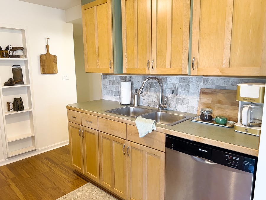 Kitchen with dishwasher and coffee maker.