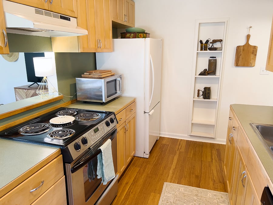 Microwave, full size oven, and full size refrigerator in kitchen.