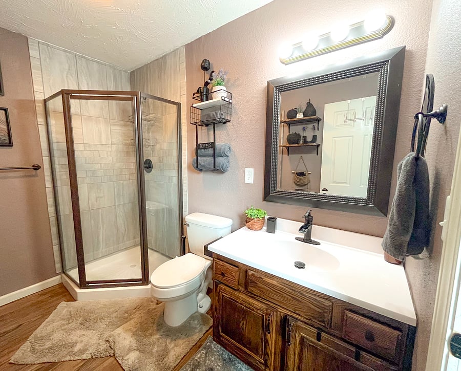 Enjoy a sparkling brand-new countertop, sleek waterfall faucet, lighted mirror, and plenty of drawer/cabinet space with a hairdryer included for your convenience. Custom diy art adds a personal touch. 