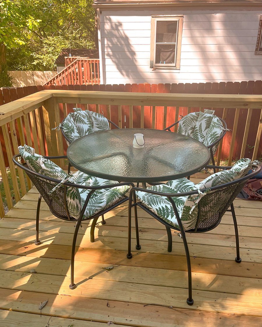 A new spacious deck with a 4-seater dining table with comfy chairs & cushions invites you to dine outside. Additional seating, hanging plants, and overhead lights create a cozy atmosphere for hanging out. 