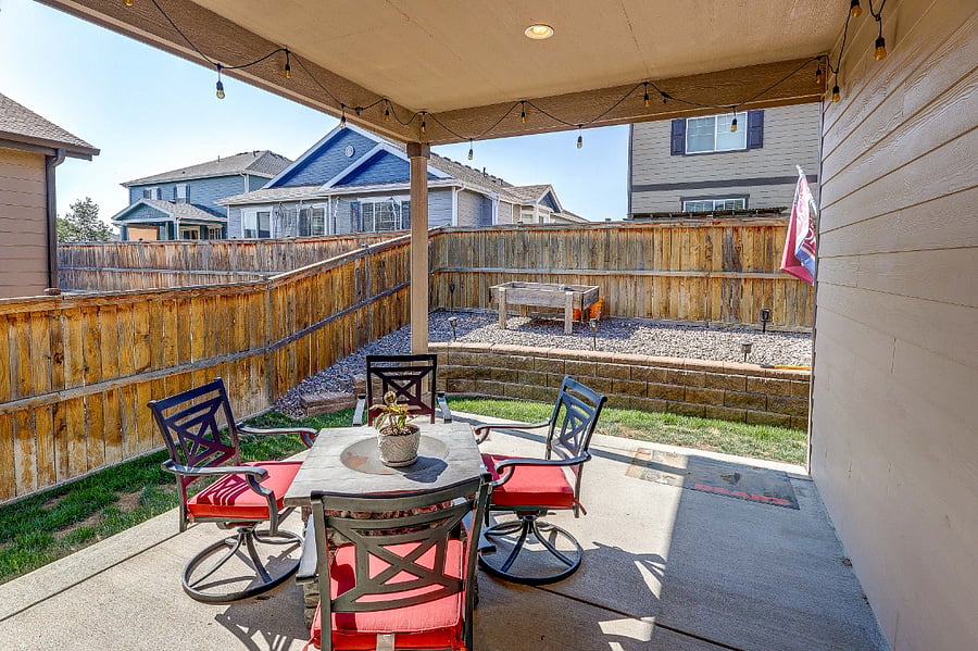 Scenic covered back porch with firepit table and chairs! Grill will be added for your BBQing pleasure