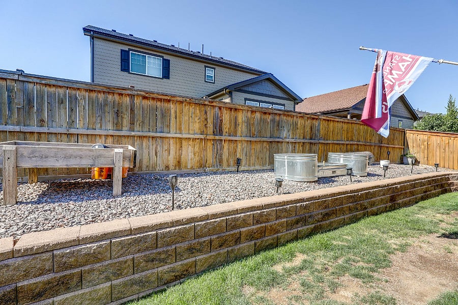 Fabulous fenced backyard with grass and raised garden area. Raised garden box and planter boxes included for your green thumb!