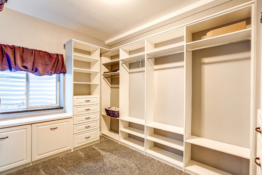 Custom walk in closet in master bedroom suite including laundry storage and jewelry drawer. Closet fit for a King and/or Queen!