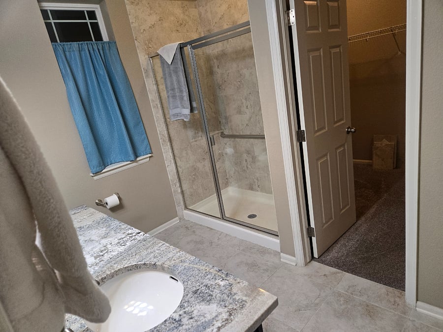 Gorgeous private master bathroom with walk in shower and window!