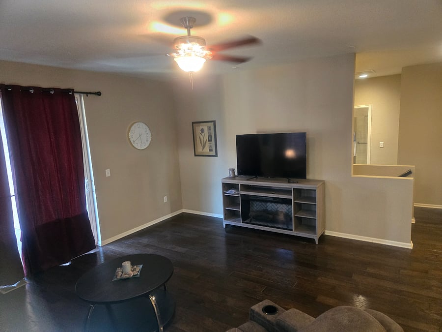 Large family room with walkout to back porch. Electric fireplace, ceiling fan and Roku TV ready to go!
