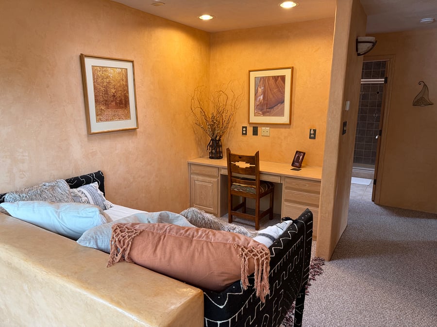 Built-in desk in the well-lighted loft area at the top of the stairs, with a daybed for an additional guest.