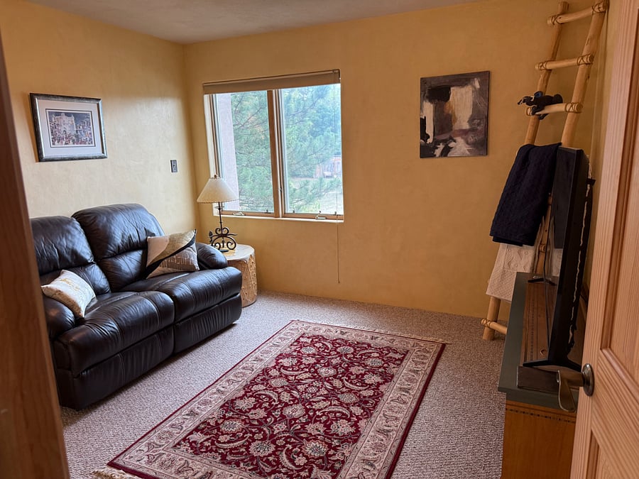 Entertainment room with flat-screen tv and electrically operated dual recliner.