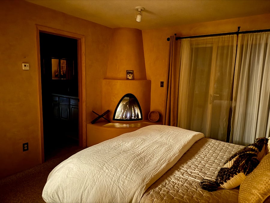 The kiva fireplace (switch-operated) makes this bedroom a relaxing, cozy retreat on a winter evening.