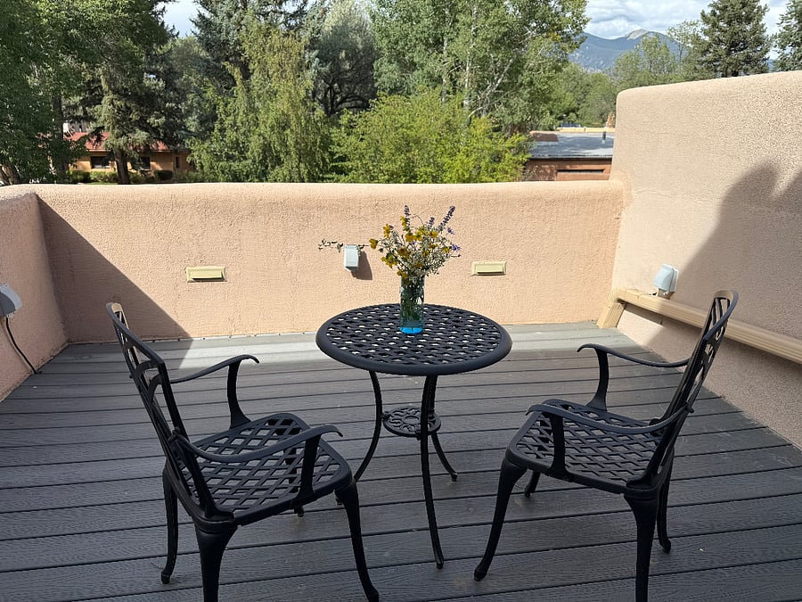 This is the deck off of the primary bedroom, with a bistro table perfect for enjoying a morning coffee or an evening glass of wine, with a view!