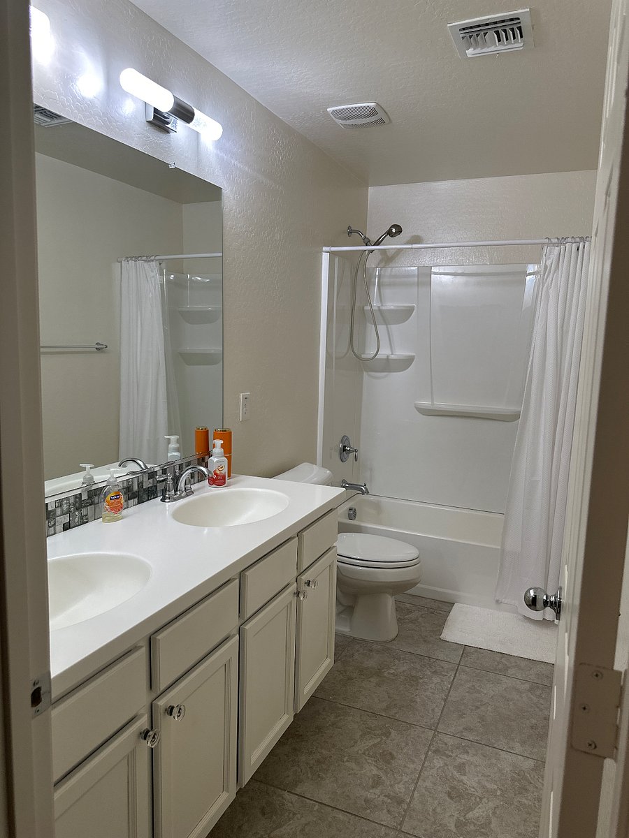 Upstairs bathroom with double sinks and storage