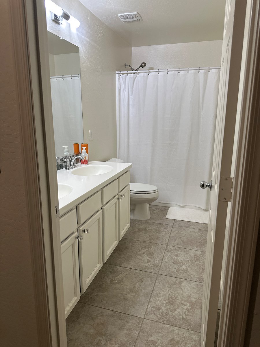 Upstairs bathroom with double sinks and storage