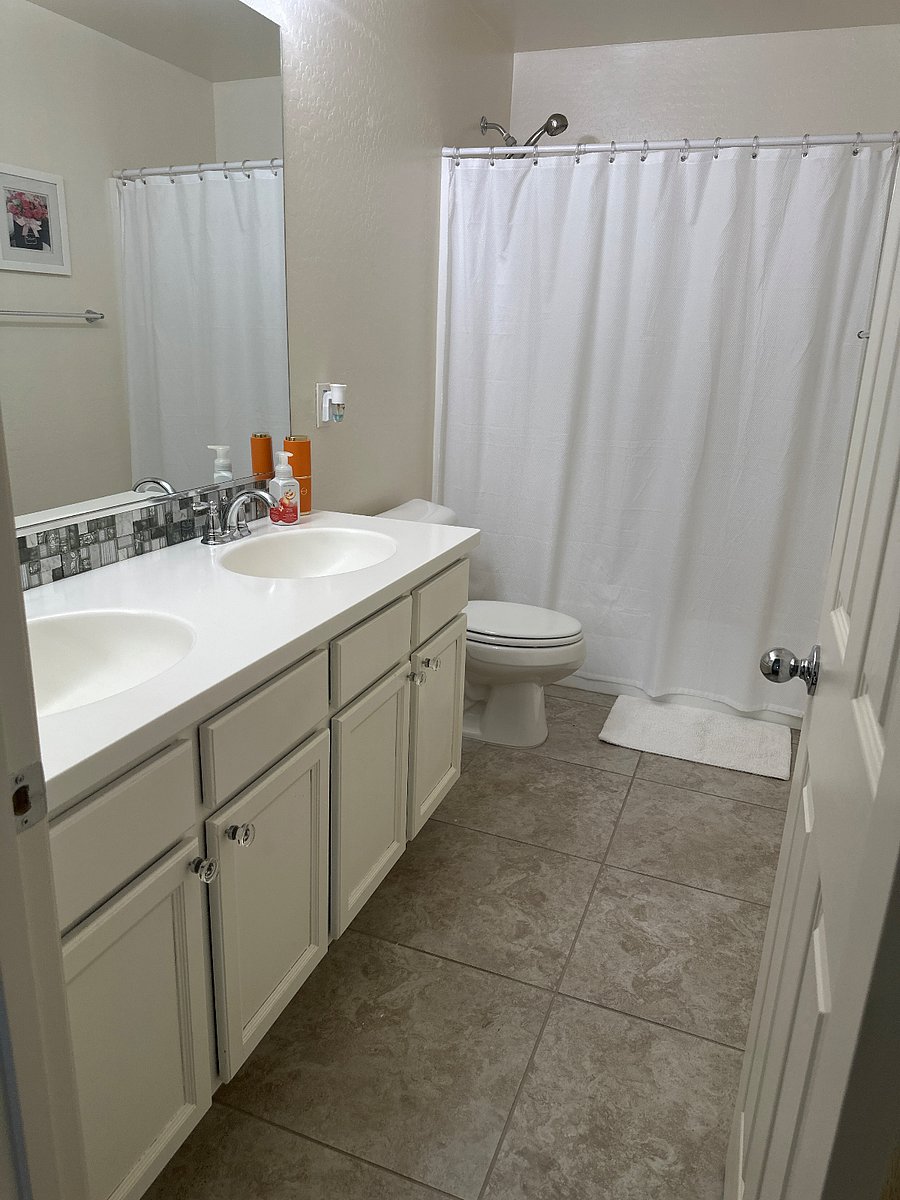 Upstairs bathroom with double sinks and storage