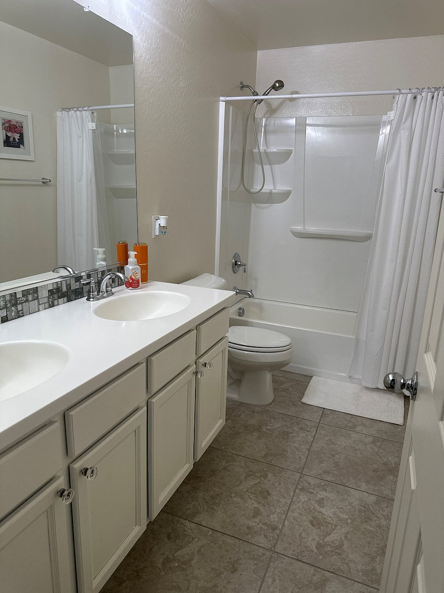 Upstairs bathroom with double sinks and storage