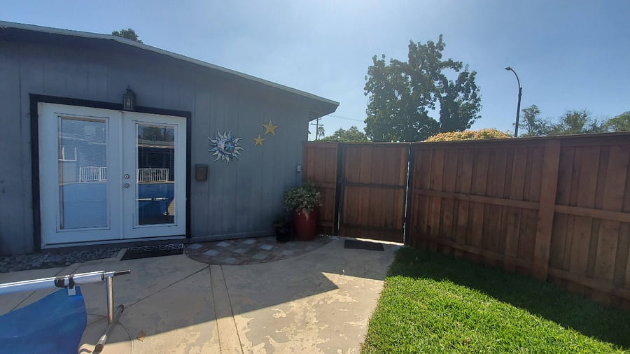 Gate to driveway from fenced yard
