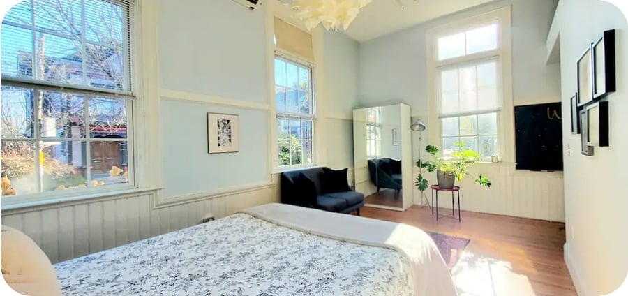 Bedroom features an armoire with drawer storage.  