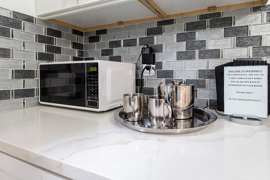 The microwave is located in the bedroom area.