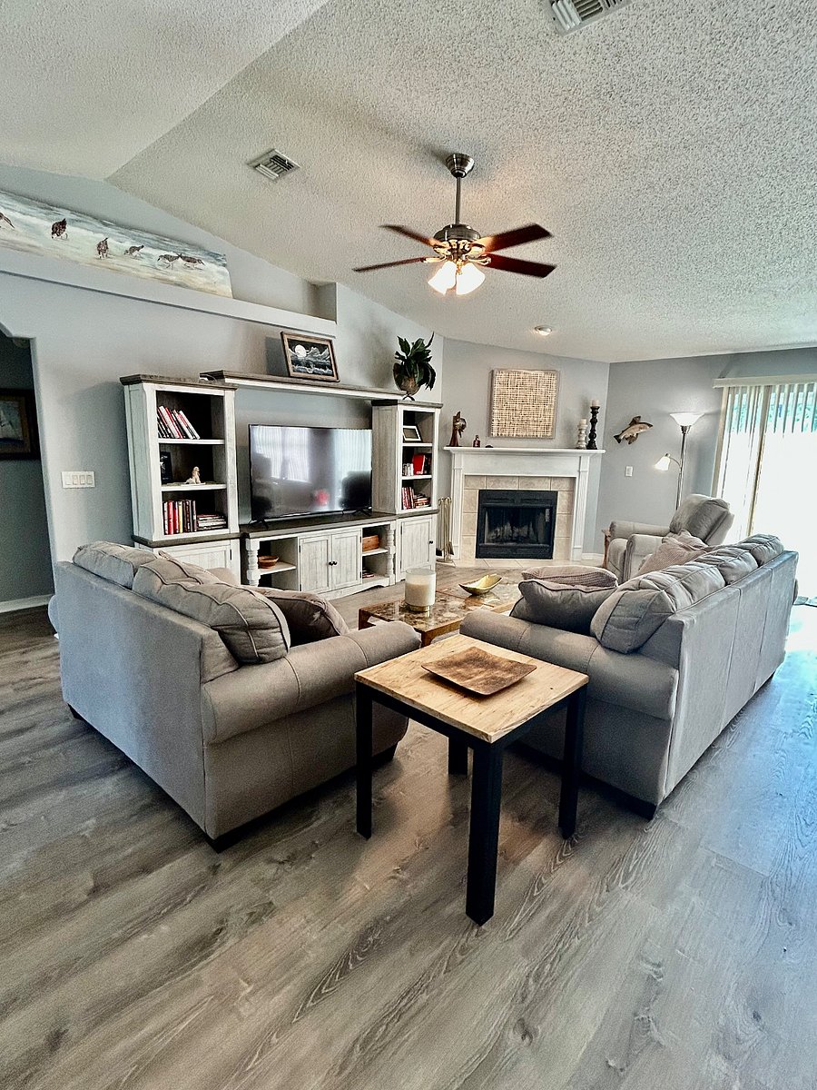 Family room with fireplace and large smart screen TV.