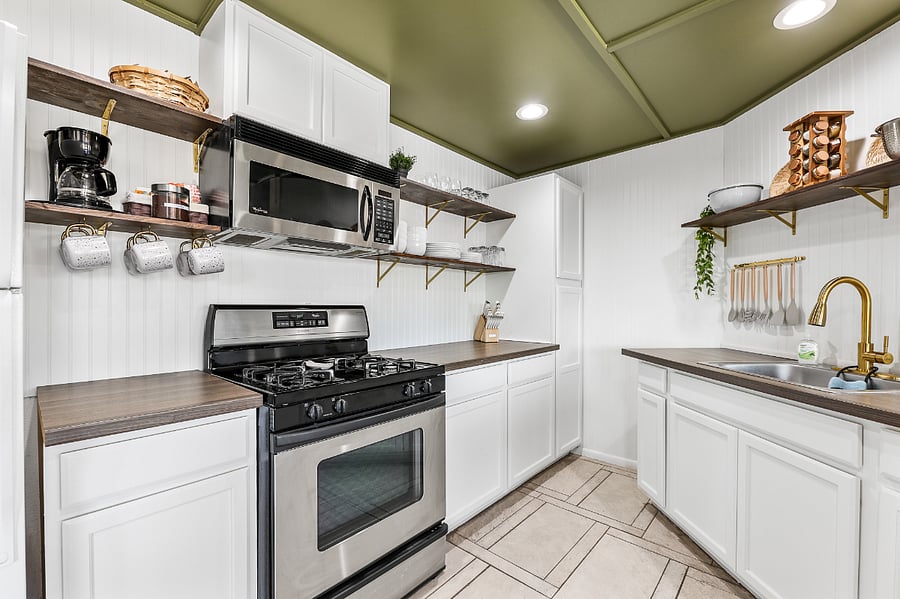 Kitchen featuring open shelving to included dish ware