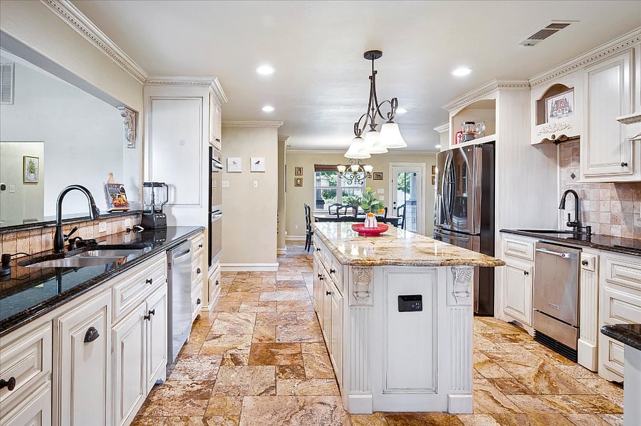Fully equipped chefs kitchen with double ovens, electric cooktop, full-size refrigerator, dishwasher, dual sinks perfect for extended stays and entertaining