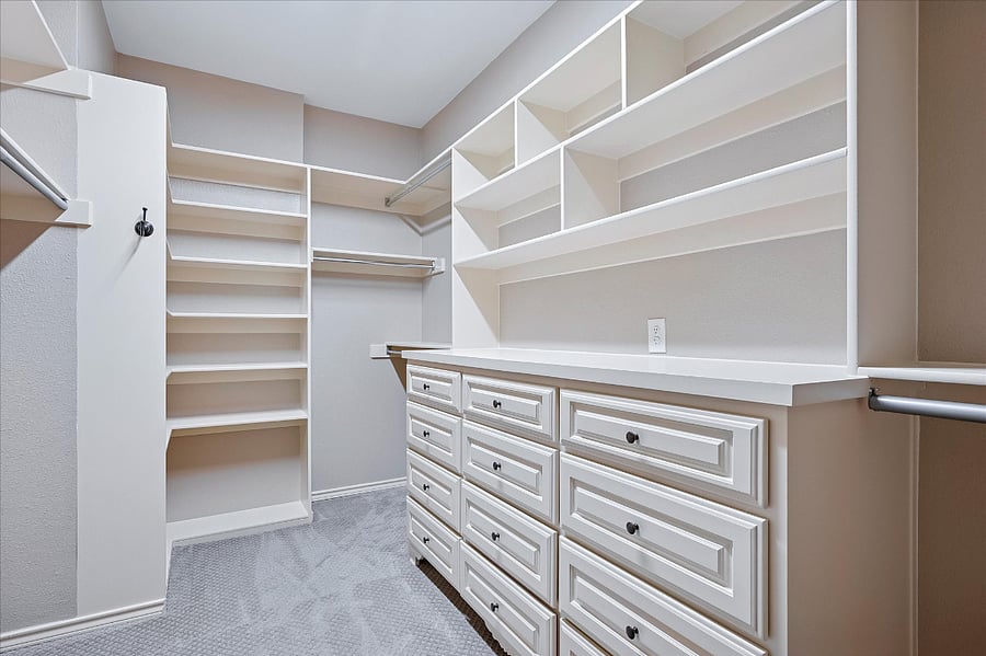 Spacious walk-in closet designed for her, offering ample storage and organization.