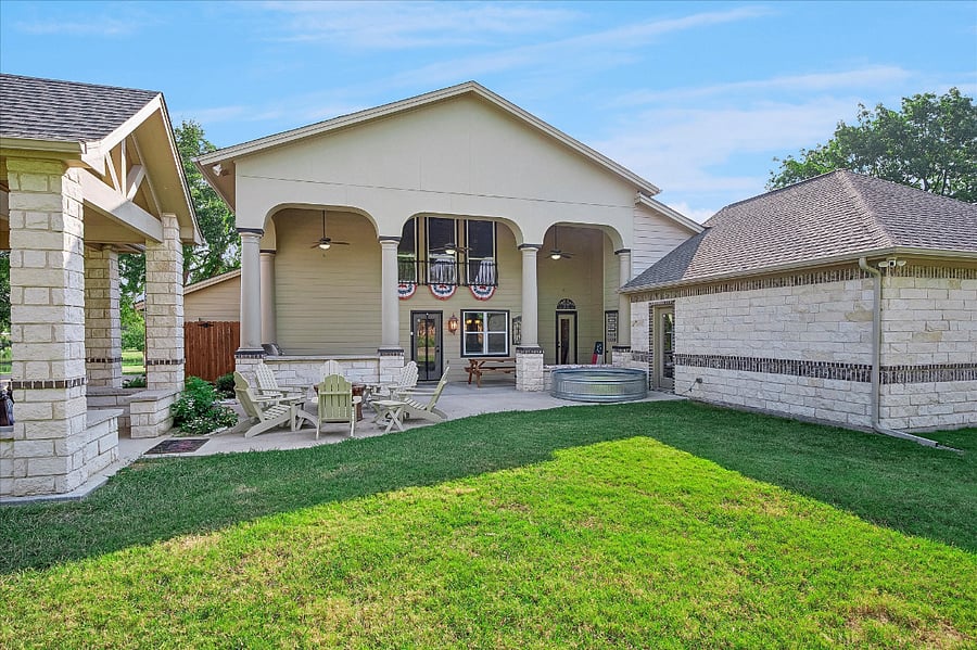 Expansive backyard with BBQ grill, ample seating, cowboy pool, perfect for gatherings, and relaxation