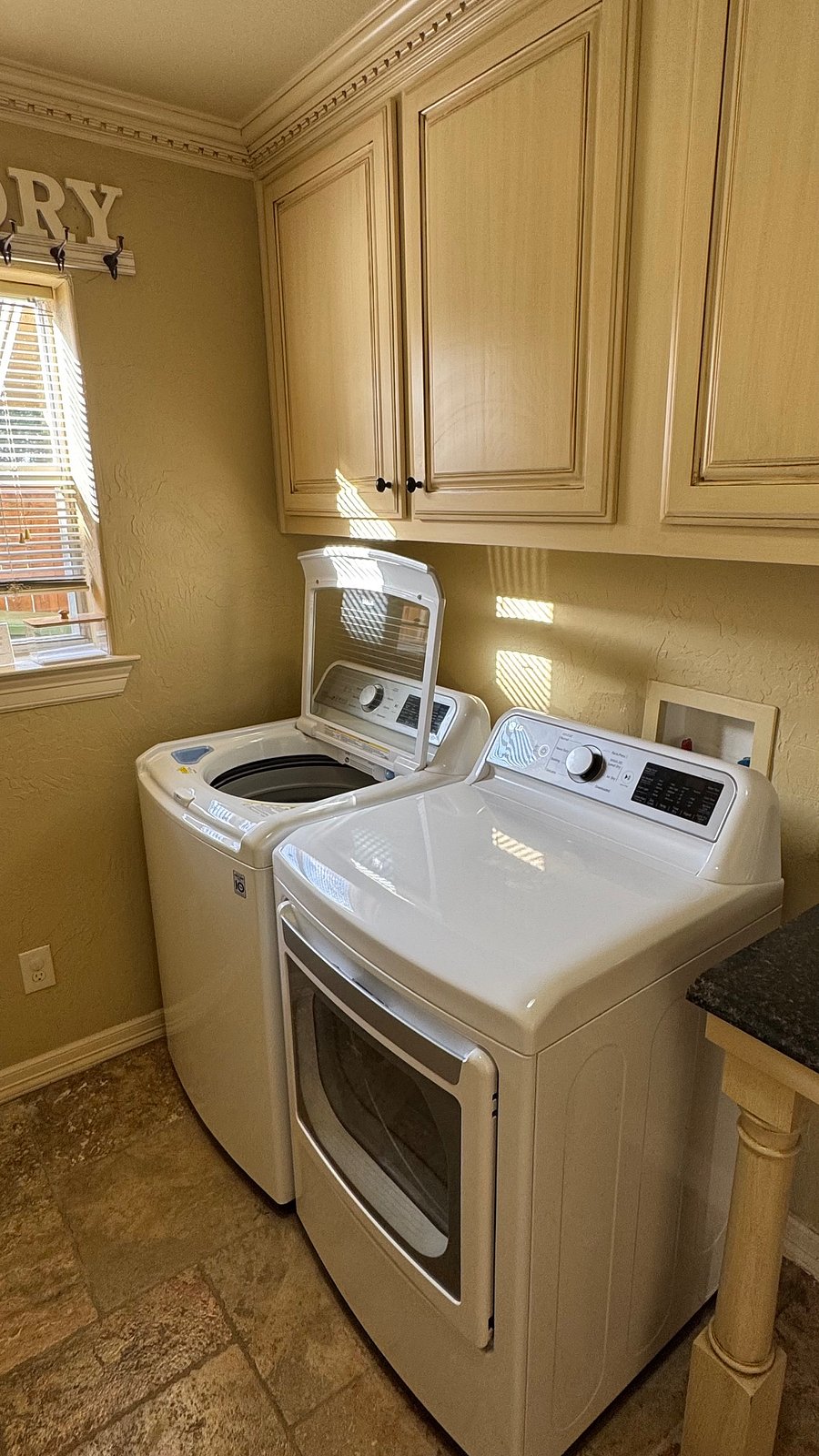 Fully equipped laundry room with a large washer and dryer. 