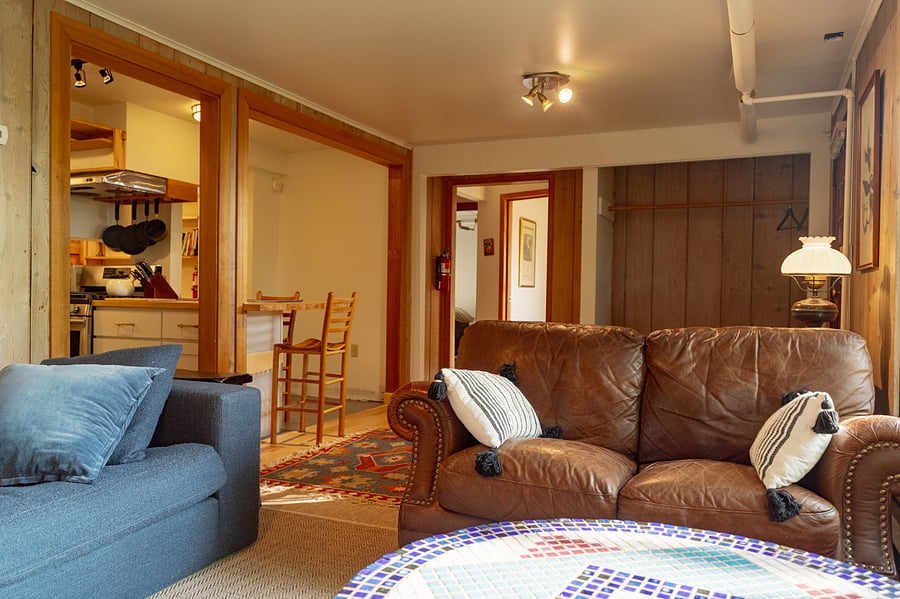 Living room looking into fully equipped kitchen