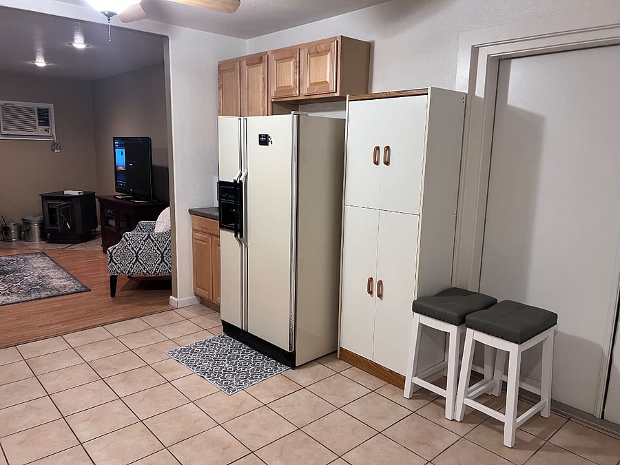 Kitchen with full size refrigerator.